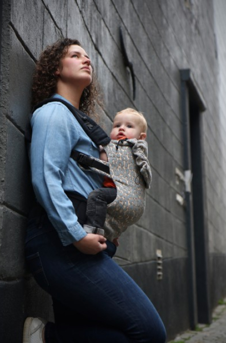Mother carrying baby in a sling