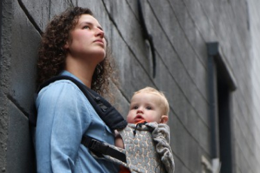 Mother carrying baby in a sling small